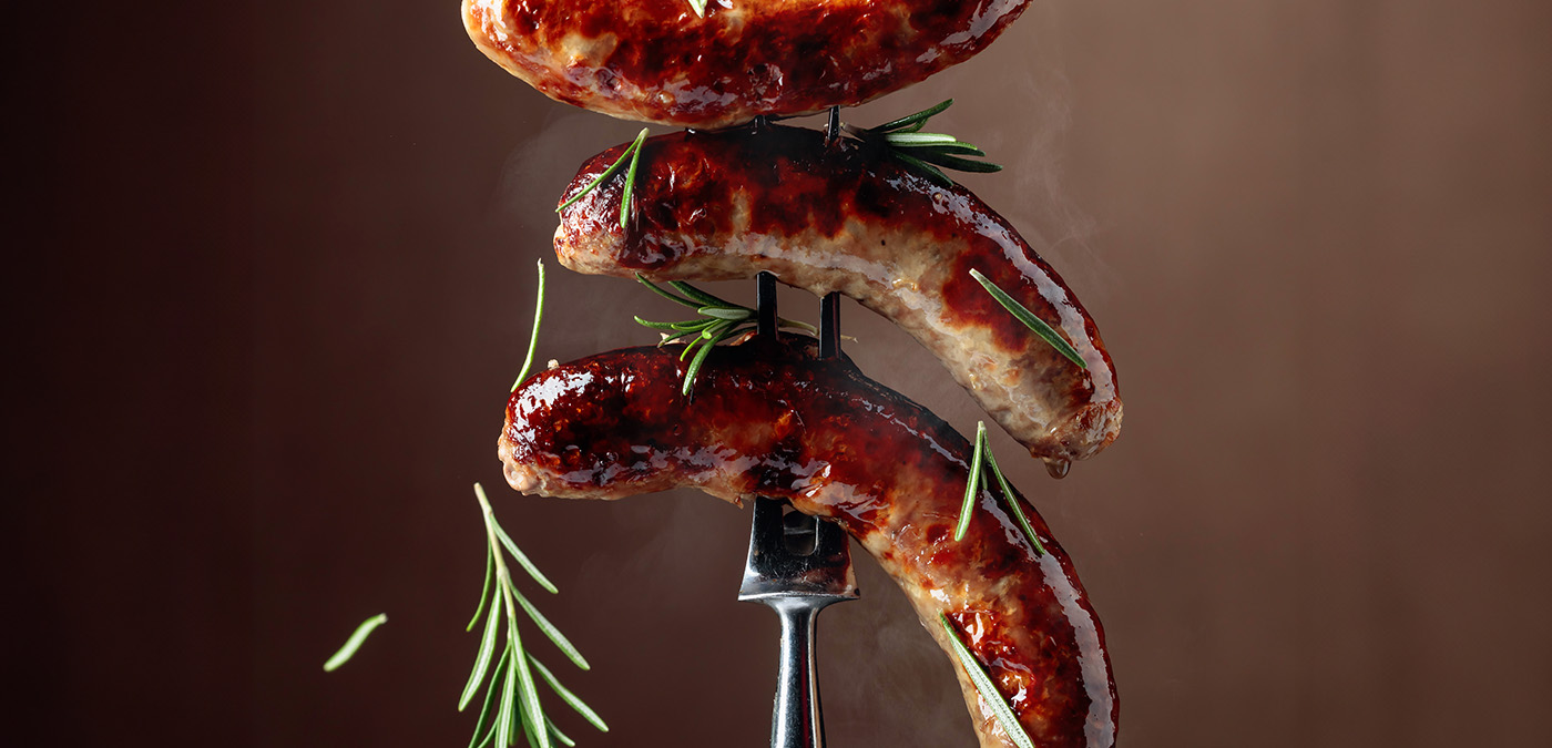 Freshly cooked sausage on a fork