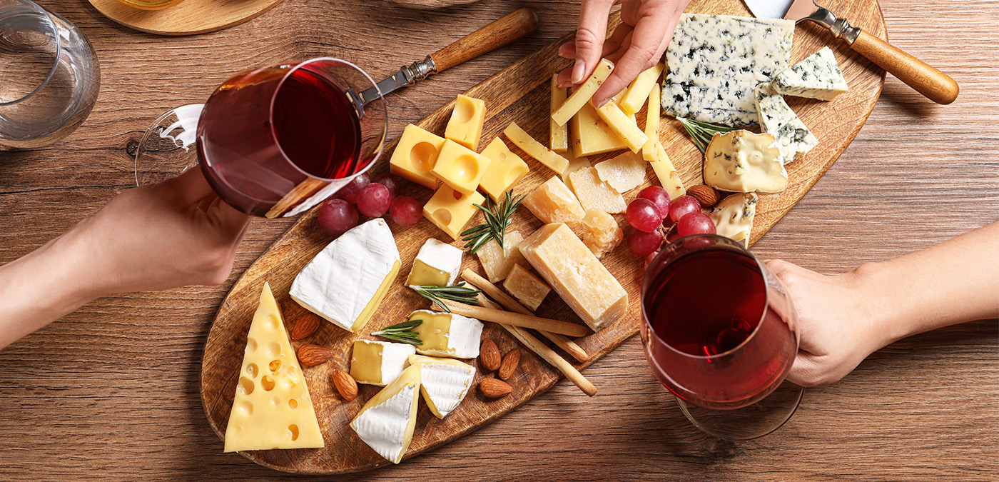 A charcuterie board with different types of cheese