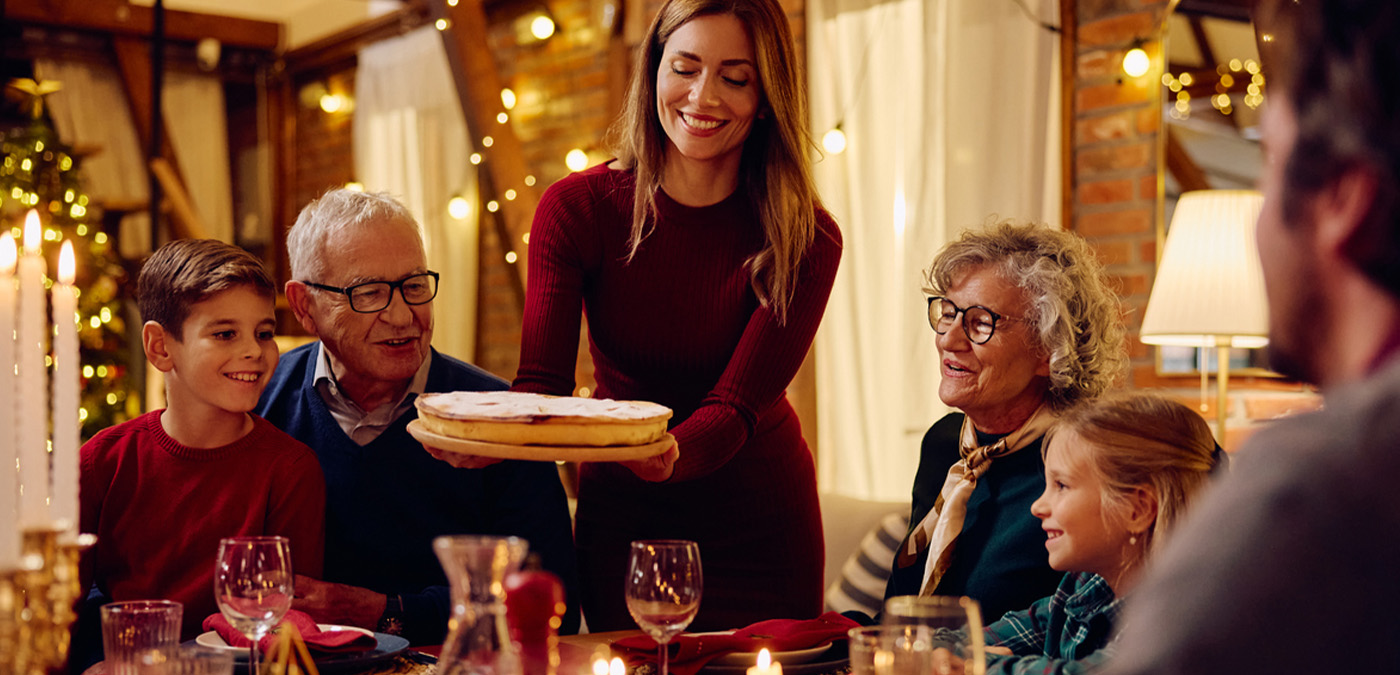 Serving pie to family at Christmas dinner